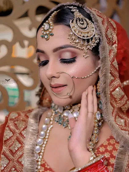 A soft, elegant portrait with the bride's eyes closed, focusing on the makeup and delicate pose.