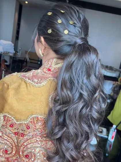 A close-up of the coin-adorned ponytail, showing the intricate placement of the accessories.