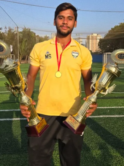 Coach Mohit Singh with two of the trophies our teams won, a proud moment for our coaching staff.
