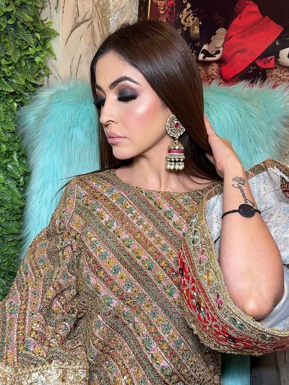 The final look. The combination of the intense smokey eye, glowing skin, and traditional jewelry is absolutely stunning.