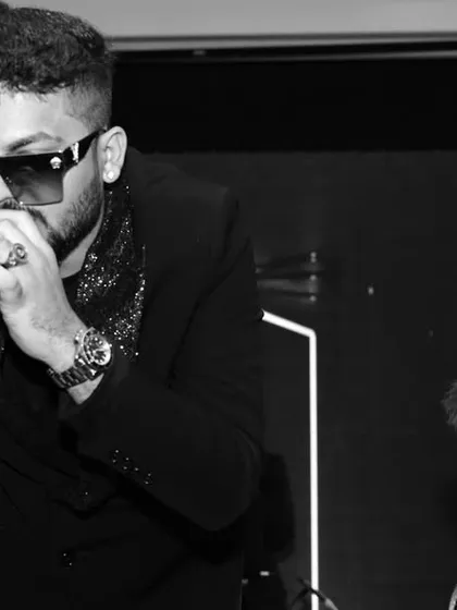 A powerful black and white shot of two singers performing a duet. This style emphasizes the raw emotion and energy of the performance without the distraction of color.
