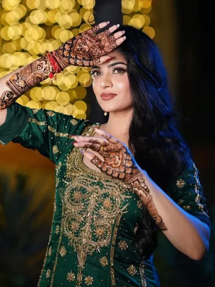 A professional photo of a bride, where her intricate mehndi is a key part of her stunning look.