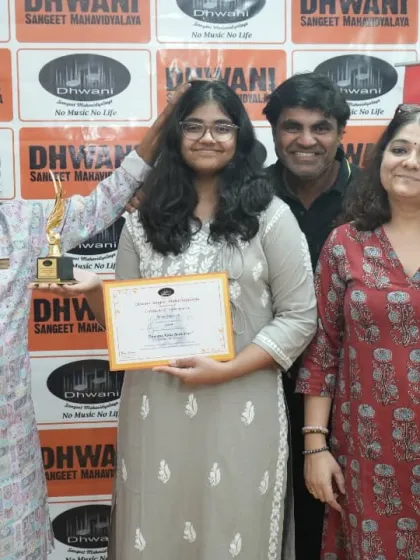 A student with her family and our senior guru, celebrating her achievement.