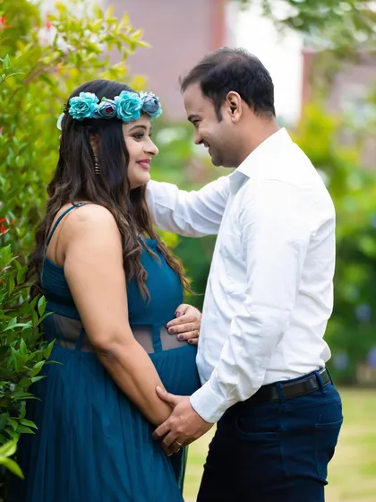 A loving couple's portrait in a garden. The natural light and greenery provide a soft and romantic backdrop for this intimate moment.