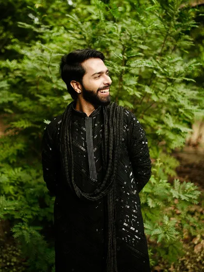 A smile that shows confidence. This black sequined kurta is perfect for a wedding look that is both modern and rooted in ethnic style.