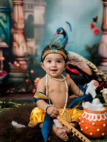 A happy, smiling little Krishna. The vibrant colors and detailed backdrop make these photos so special.