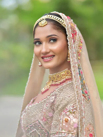 A smiling shot of this lovely bride. Her soft, glowy makeup looks fresh and radiant in the natural outdoor light.