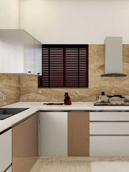 This kitchen corner shows a chimney, hob, and a sink with a window above it. The design includes open, backlit shelves for frequently used items or decor.