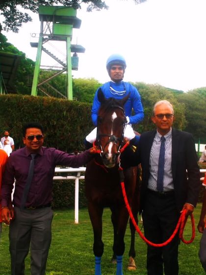 Imperial Blue, with jockey Pavan, stands with the winning team.