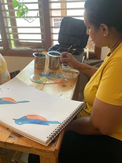 A student practices painting simple bird forms. This exercise helps in understanding shape, color blocking, and basic anatomy before moving to more detailed work.