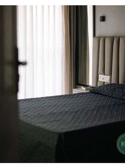 A moody and atmospheric shot of a bedroom, focusing on the channel-tufted headboard. This image captures the tranquil and restful feeling our bespoke bedroom furniture is designed to evoke.