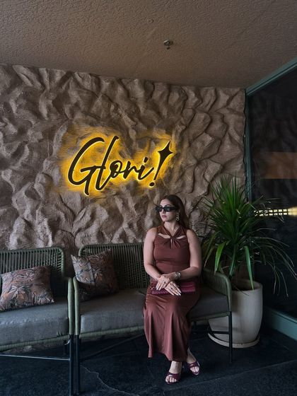 Posing at the venue for our dining etiquette session. The halter-neck detail of this brown dress adds a touch of sophistication, making it suitable for a semi-formal setting.