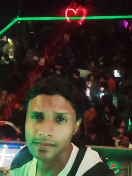 A selfie from the DJ booth with a massive crowd behind me and a neon heart glowing above. The love from the crowd is real.