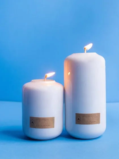 The limited-edition Volumetric Curve candles in a clean, classic white. These candles are designed to elevate your home with fragrances that inspire vitality, housed in a pastel palette to match any decor.
