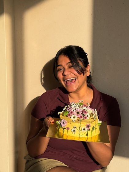 That's me, absolutely thrilled with how this Pinterest-worthy floral cake turned out. It’s moments like these that make me love what I do.