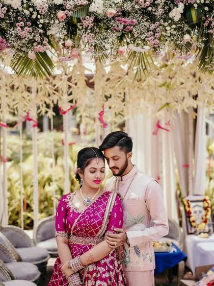 An intimate portrait of the couple under a beautiful floral mandap at their engagement ceremony.