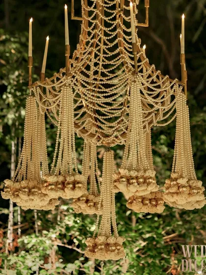 Luxury is found in the finest details. This custom-designed chandelier, crafted from intricate strands of pearls and delicate floral buds, showcases our dedication to bespoke artistry and exquisite craftsmanship.