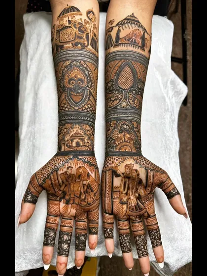 This full bridal mehendi tells a complete story, from the couple's portrait on the palms to the intricate wedding procession with elephants and palanquins covering the forearms. It's an example of how I weave personal narratives into traditional henna art.
