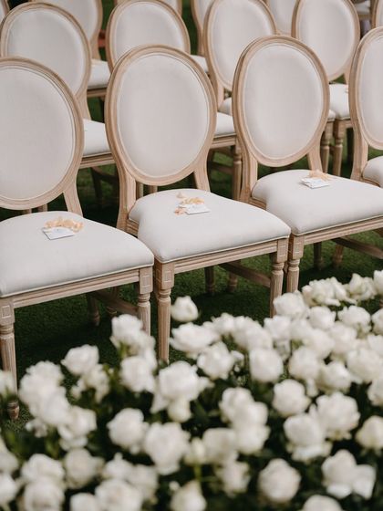 A close-up of the guest seating, with delicate flower petals placed on each chair.