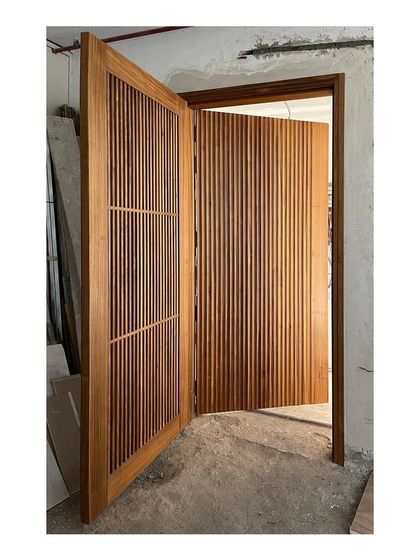 The entry screen and main door, built from solid teak with a natural matte polish. I design entryways to be an impressive first statement, and this piece showcases my commitment to solid wood craftsmanship.