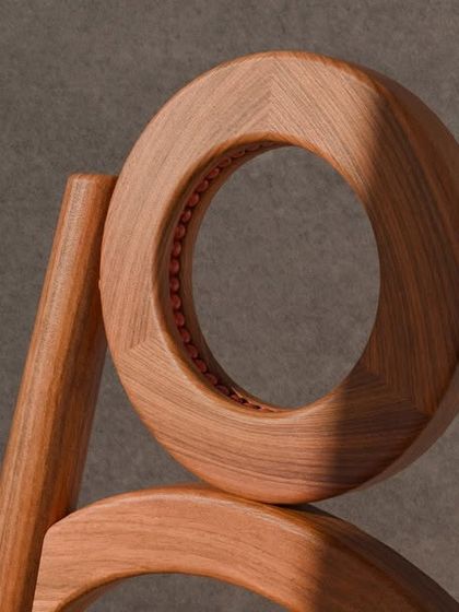 A series of images detailing the Manjadi chair, from its hand-turned legs inspired by the seed pod to the vibrant red upholstery. These shots highlight the craftsmanship and the deep cultural narrative behind this unique design.