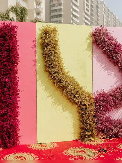 A modern and artistic photo backdrop made of colorful panels and textured floral installations. This provides a unique and Instagram-worthy spot for guests.