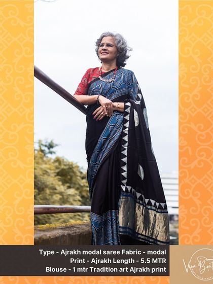 A happy customer looking absolutely elegant in our black Ajrakh modal saree. The geometric and floral block prints in shades of blue and white stand out beautifully against the dark fabric.
