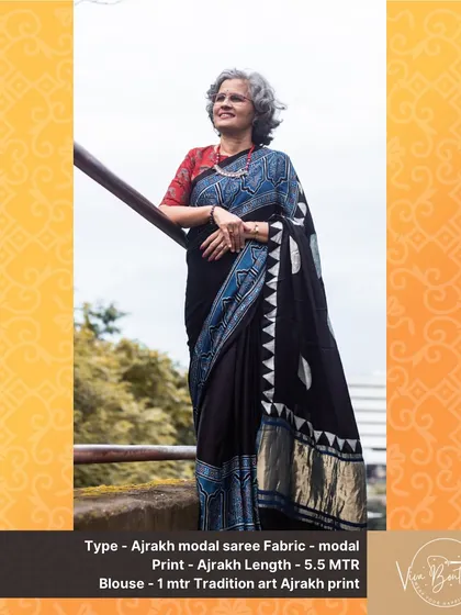 A happy customer looking absolutely elegant in our black Ajrakh modal saree. The geometric and floral block prints in shades of blue and white stand out beautifully against the dark fabric.