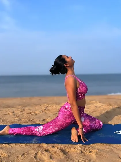 Eka Pada Rajakapotasana (Pigeon Pose) on the beach. This pose is a perfect blend of strength and serenity, a deep hip opener that feels amazing with the sound of the waves.