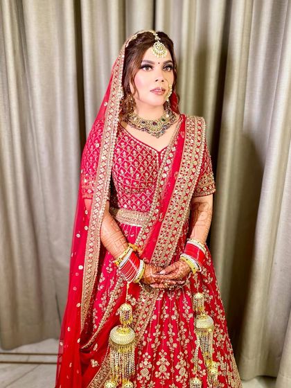 A full-length shot of Lavanya, looking poised and elegant in her complete bridal attire.