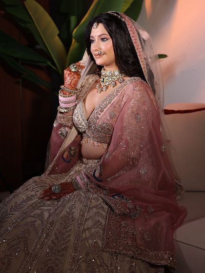 The bride looking ethereal in her pastel lehenga with a sheer pink dupatta. This look is all about soft, romantic elegance.