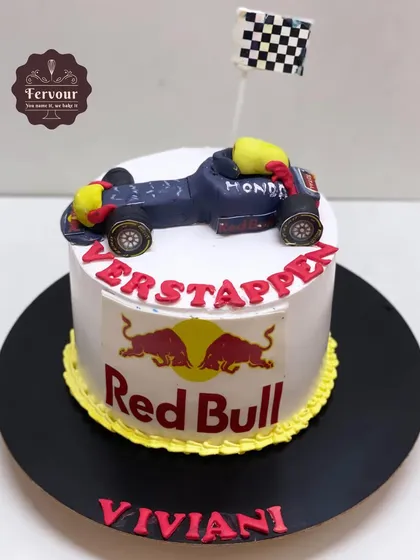 A Ferrari racing car theme cake for a fan of Verstappen and Red Bull. This chocolate truffle cake features a hand-crafted fondant F1 car.