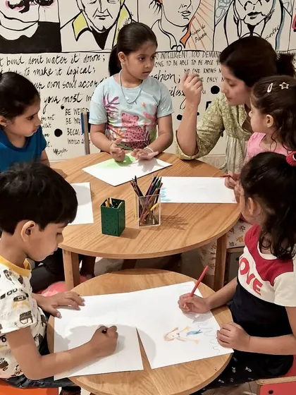 Concentration and creativity at the drawing table. During our Read-a-thon, kids listened to stories and then brought the characters and scenes to life with their own colorful illustrations.