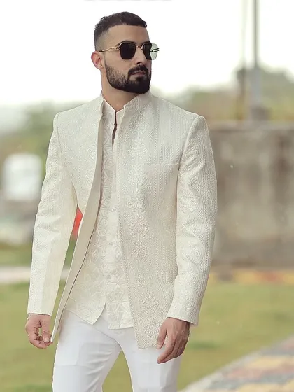 We take pride in our global clientele. Here, a client in Australia is seen in his bespoke ivory Bandhgala suit, a testament to our ability to deliver perfectly tailored elegance across continents for any wedding or formal occasion.