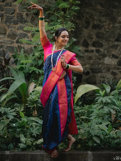 We see the art in tradition. For this bridal portrait, we incorporated the bride's passion for Bharatnatyam, capturing her grace in a classic dance pose against a lush, natural backdrop.