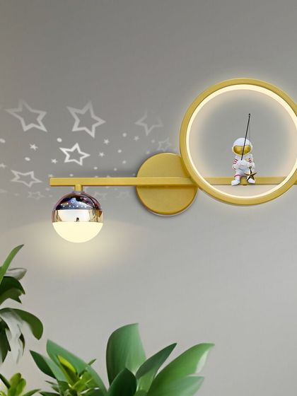 This whimsical wall light with a little astronaut figure is perfect for a kid's room. It even projects stars onto the wall, creating a fun and dreamy atmosphere.
