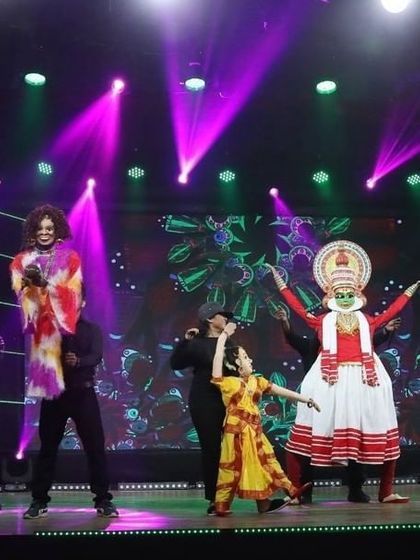 The full ensemble of dancers and puppets on stage, creating a visually stunning spectacle of color and movement for the grand finale.