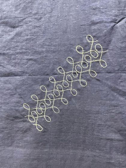 A close-up of the Sashiko stitch on the Mangalgiri saree. The looped, running pattern is both beautiful and structural, a key feature of this Japanese embroidery style.
