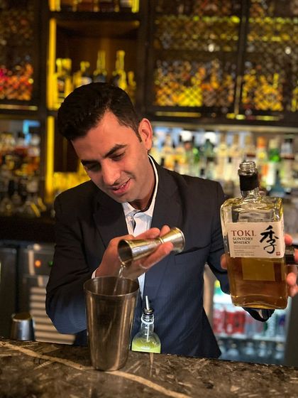 Our talented bartender is seen here crafting a cocktail with Suntory Toki whisky during our collaboration with Nadodi KL. It is this level of focus and precision that defines every drink we serve at our bar.