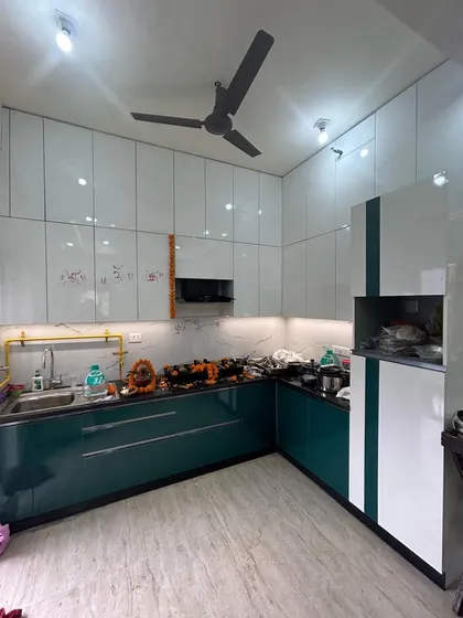 Another angle of the completed kitchen, showing the pantry and microwave unit seamlessly integrated into the design. Every inch of space is utilized for maximum storage and convenience.