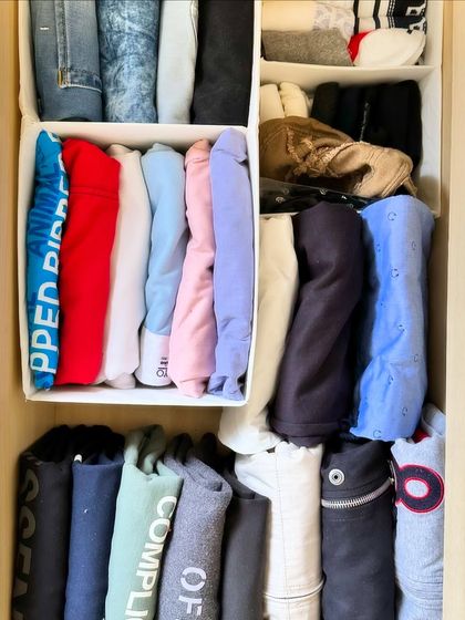 We use drawer organizers to file-fold sweatshirts and hoodies. This vertical storage method makes it easy to see every color and style at a glance.