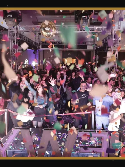 The countdown moment at a New Year's Eve corporate party. A blast of confetti rains down on an excited crowd as they cheer in the new year, a high-energy climax planned and executed by our team.