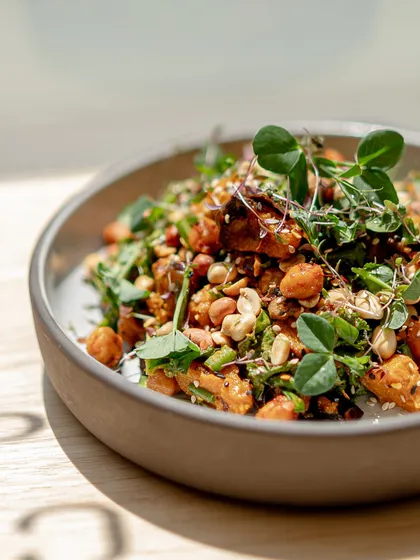 The Asian Peanut Salad catching the light. We use fresh pea shoots to add a delicate, fresh finish to this hearty and flavourful dish.