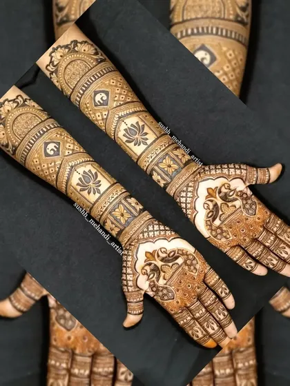 A creative layout showing a full bridal design. This pattern has bands of elephants and lotus flowers, with peacocks on the palm.