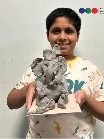 Creativity in the details. This student not only sculpted a beautiful Ganpati but also added the accompanying mouse and sweets, making his creation complete.