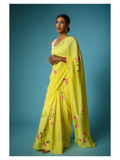 Another angle of the yellow saree, showing the model in a slightly different pose. Providing these variations is key for a comprehensive brand lookbook.