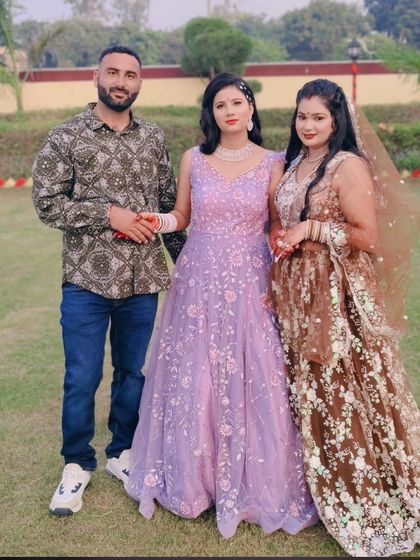 A group photo from a client's event, featuring our brown floral lehenga and a lavender floral gown.
