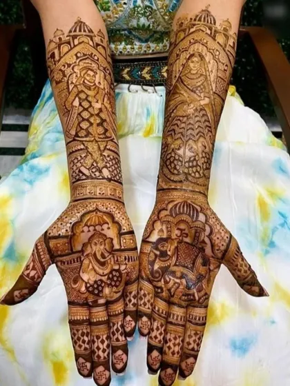 A design filled with blessings, featuring Lord Ganesha on one palm and a bride in her doli on the other. The arms show a groom on an elephant and other traditional figures.