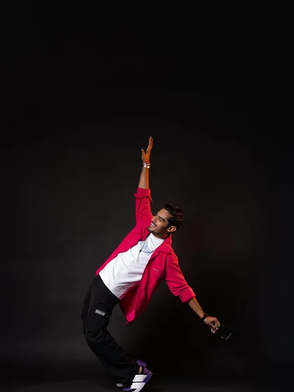 For this look, I styled Amit in a bright pink shirt over a simple white tee and black joggers. It's a casual, energetic, and youthful look, perfect for his brand as "The Indian Unboxer."