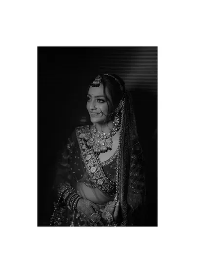 A beautiful black and white portrait of the bride. The simple composition and her gentle smile create a classic and elegant feel.